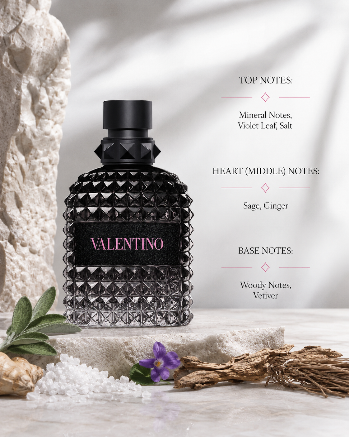 Valentino Uomo Born In Roma Eau de Toilette elegantly displayed on a textured travertine stone pedestal in soft natural daylight. The composition is inspired by mineral landscapes and is surrounded by violet leaves, fresh sage, sliced ginger root, sea salt crystals, weathered vetiver roots and rugged driftwood. Neutral limestone textures, subtle botanical shadows and a refined Italian luxury aesthetic create a modern masculine atmosphere. 