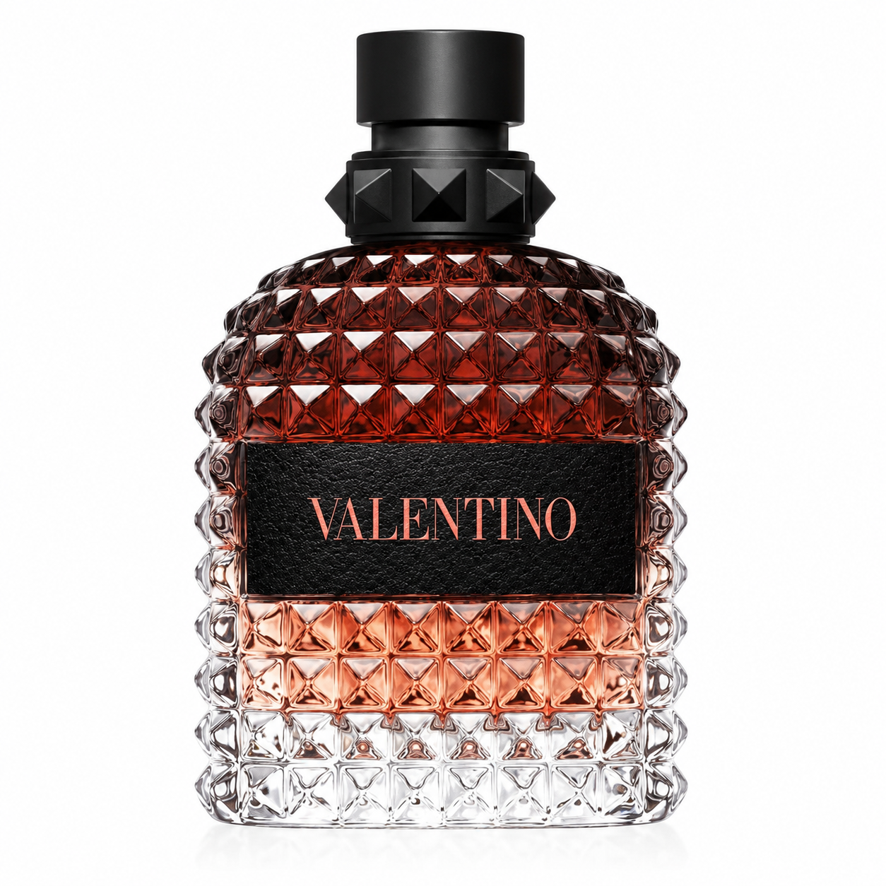 Valentino Uomo Born In Roma Coral Fantasy Eau de Toilette presented in its iconic Rockstud-inspired faceted glass bottle with a warm amber-to-clear gradient, luxurious matte black studded cap and elegant Valentino plaque. Displayed on a flawless pure white background with premium studio lighting, crystal-clear reflections, soft natural shadows and exceptional detail that highlights the bottle's modern Italian couture design.
