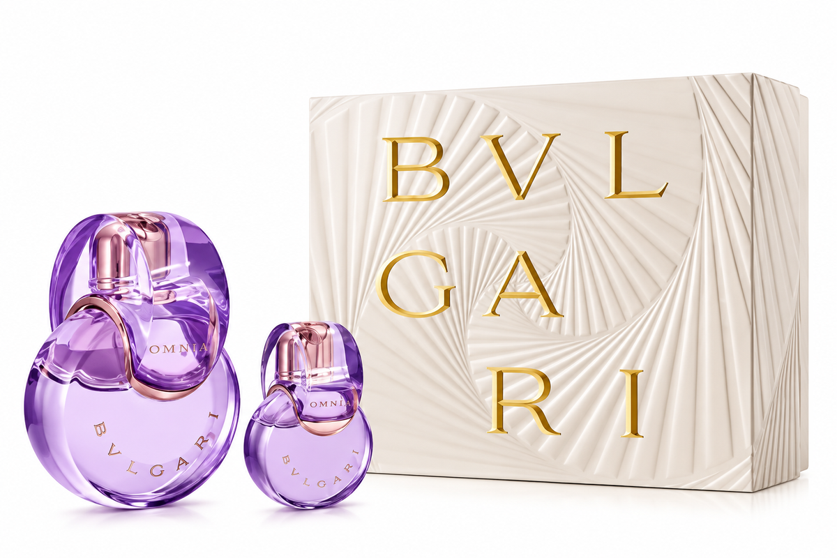 Bvlgari Omnia Amethyste perfume gift set for women, featuring two elegant purple fragrance bottles in different sizes with sculptural circular designs and rose-gold accents, alongside a luxurious ivory Bvlgari gift box with embossed patterns and gold lettering, displayed against a clean white background.