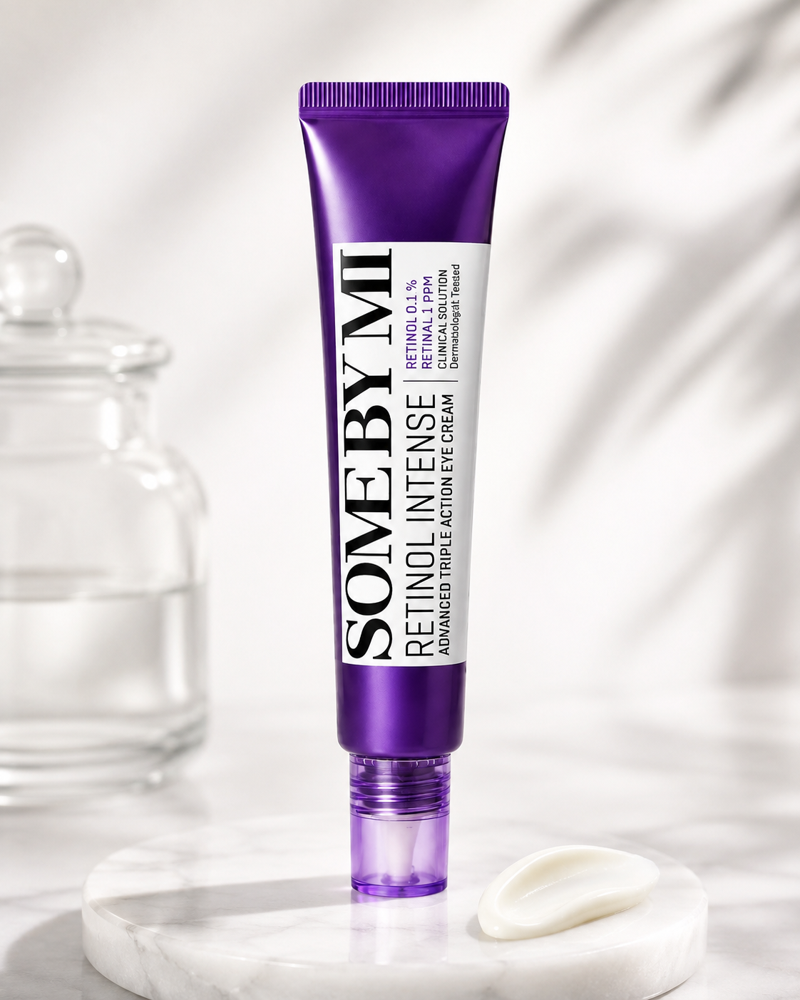 SOME BY MI Retinol Intense Eye Cream displayed on a clean marble surface in a soft, clinical-inspired skincare setting, with a cream swatch highlighting its smooth, nourishing texture.